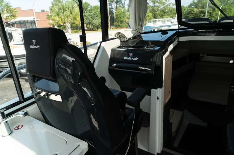 Slide: The Image of Interior of 2025 Wellcraft 355 boat, featuring sleek helm and comfortable seating. - 18