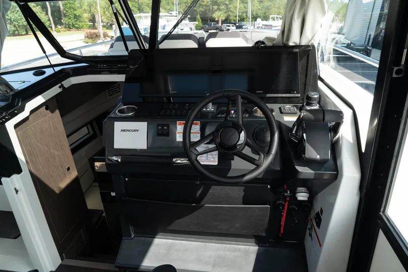 Slide: The Image of 2025 Wellcraft 355 boat cockpit with modern steering and control panel. - 21