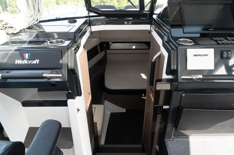 Slide: The Image of 2025 Wellcraft 355 boat interior with modern design and Mercury controls. - 22