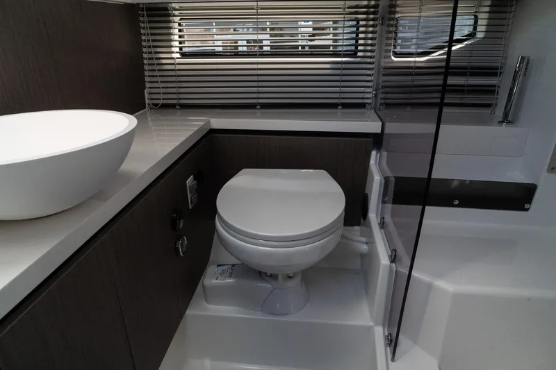 Slide: The Image of Modern bathroom in 2025 Wellcraft 355 yacht with sleek fixtures and blinds. - 29