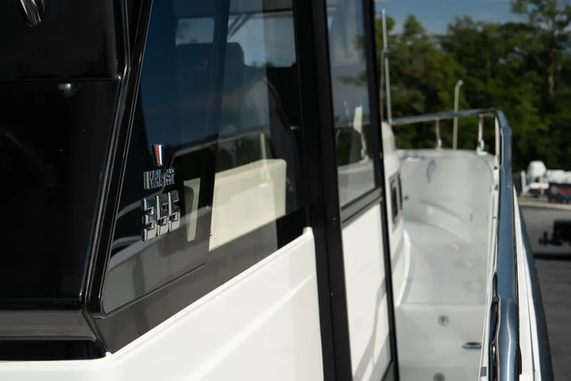 Slide: The Image of 2025 Wellcraft 355 boat, sleek design, side view with railing and windows. - 33