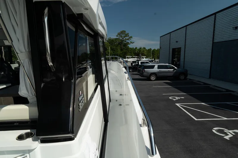 Slide: The Image of 2025 Wellcraft 355 yacht docked near a parking lot, showcasing sleek design and modern features. - 34