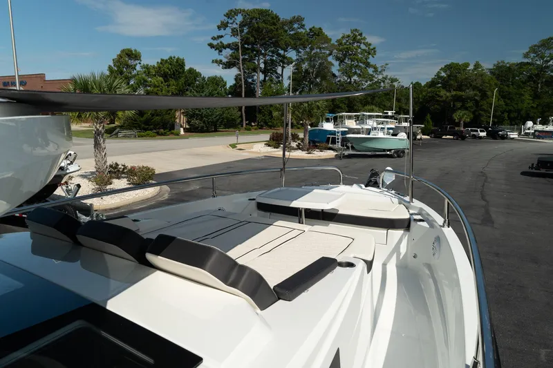 Slide: The Image of 2025 Wellcraft 355 boat with sleek deck design, parked outdoors. - 37