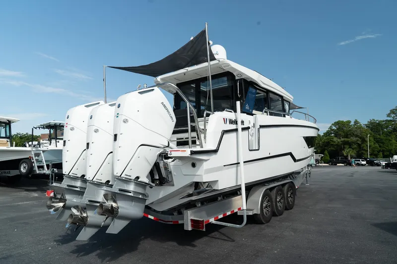 Slide: The Image of 2025 Wellcraft 355 boat with triple outboard engines on a trailer. - 5