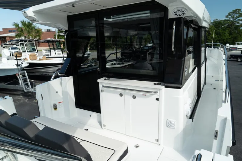 Slide: The Image of 2025 Wellcraft 355 boat with sleek design and modern features, docked outdoors. - 9