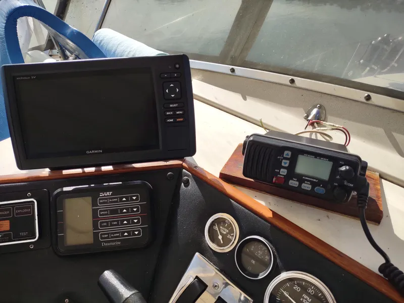 Slide: The Image of Control panel of a 1988 Marinette Marquis Motor Yacht with navigation and communication equipment. - 12