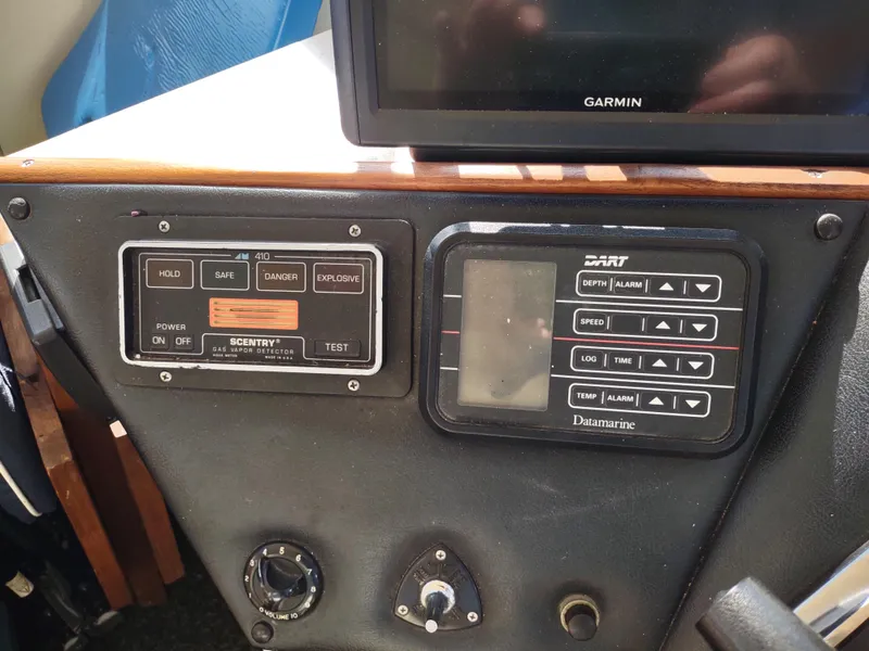 Slide: The Image of Control panel of a 1988 Marinette Marquis Motor Yacht with Garmin and Datamarine equipment. - 13