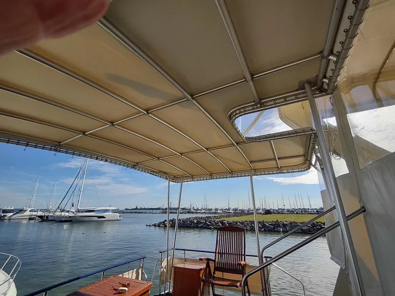 Slide: The Image of 1988 Marinette Marquis Motor Yacht deck with canopy, overlooking marina and sailboats. - 14