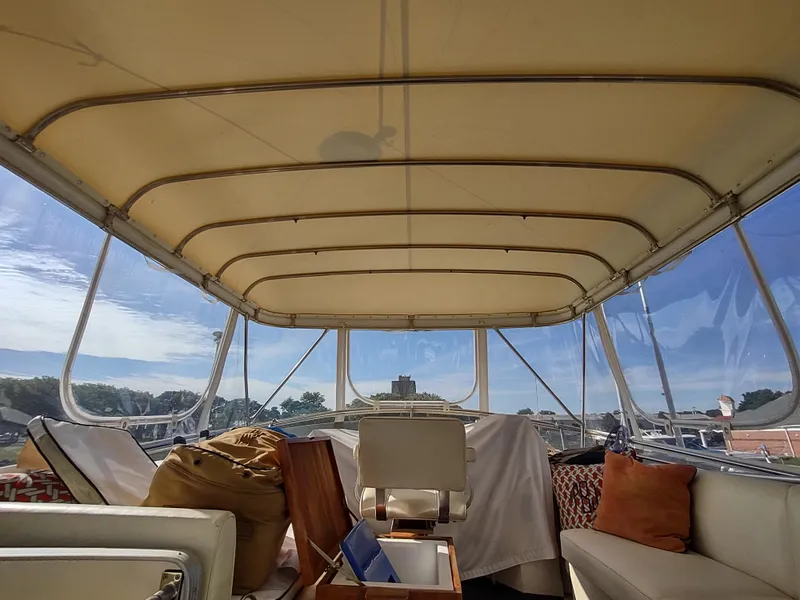 Slide: The Image of Interior view of 1988 Marinette Marquis Motor Yacht with seating and clear canopy. - 15