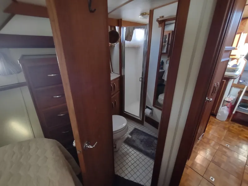 Slide: The Image of Interior of 1988 Marinette Marquis Motor Yacht showing bathroom and bedroom area. - 22