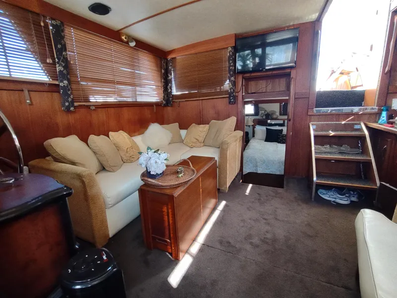 Slide: The Image of Interior of 1988 Marinette Marquis Motor Yacht with cozy seating and wooden decor. - 25