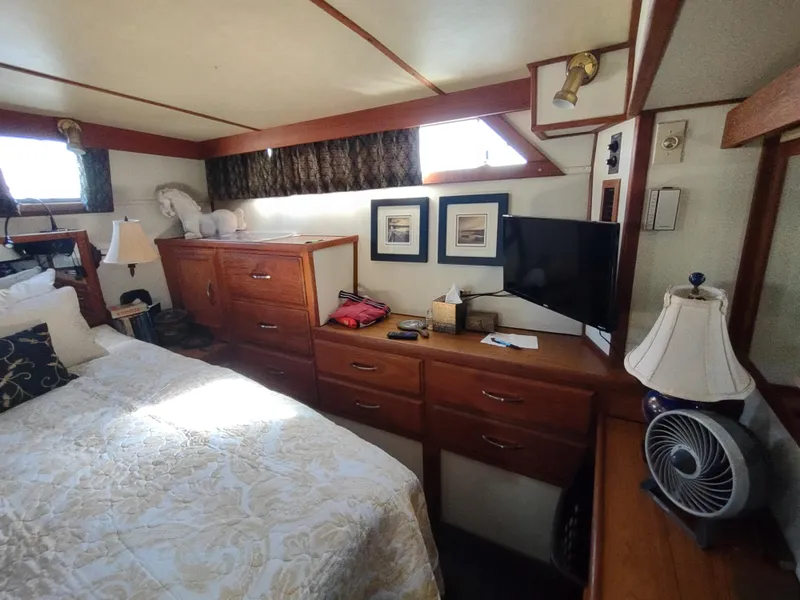 Slide: The Image of Bedroom interior of 1988 Marinette Marquis Motor Yacht with wooden furniture and decor. - 27