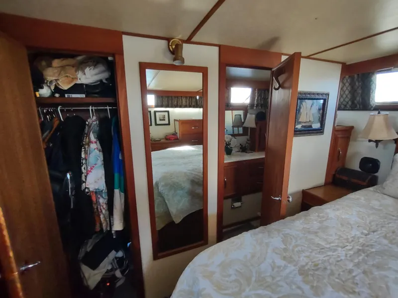 Slide: The Image of 1988 Marinette Marquis Motor Yacht bedroom with closet, mirror, and nautical decor. - 28