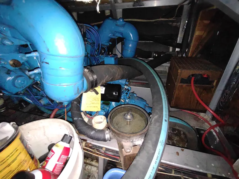 Slide: The Image of Engine room of 1988 Marinette Marquis Motor Yacht with visible blue engine components. - 34