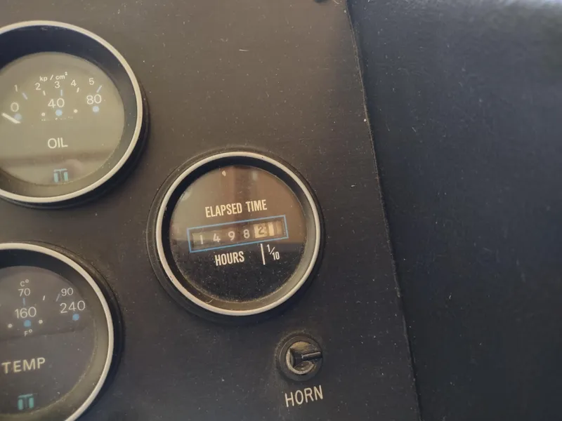 Slide: The Image of Dashboard gauges of a 1988 Marinette Marquis Motor Yacht showing oil, temperature, and elapsed time. - 37