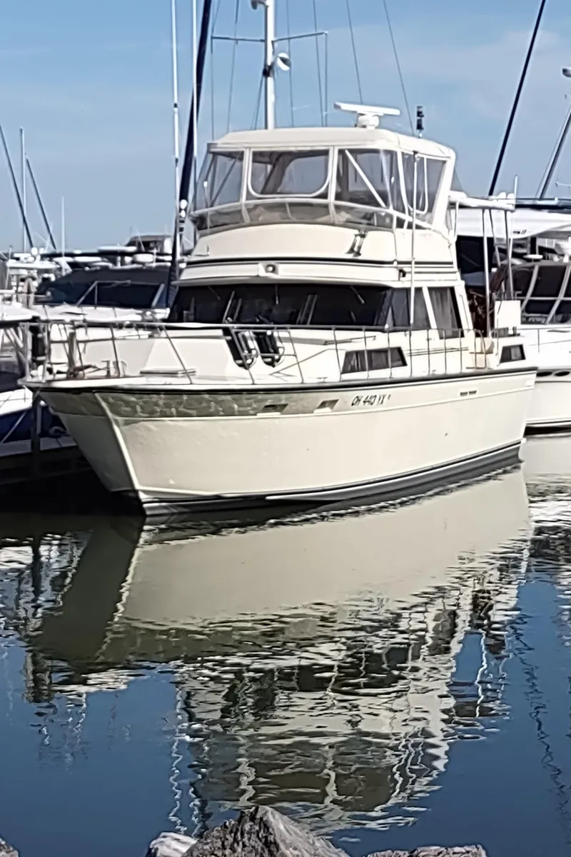 Slide: The Image of 1988 Marinette Marquis Motor Yacht docked in a marina, reflecting on calm water. - 42