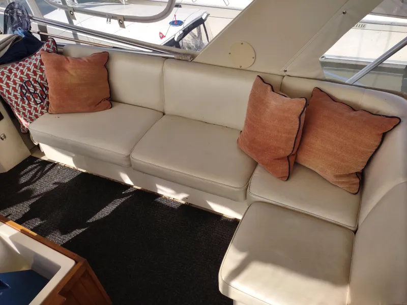 Slide: The Image of 1988 Marinette Marquis Motor Yacht interior with white leather seating and decorative pillows. - 7