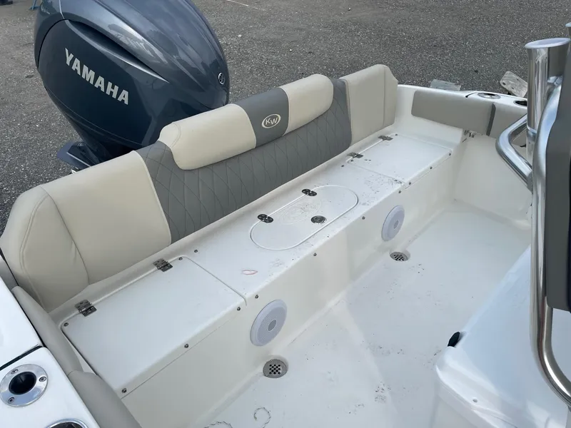 Slide: The Image of 2025 Key West 219 FS boat interior with Yamaha engine, featuring cushioned seating and storage compartments. - 6