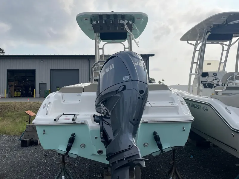 Slide: The Image of 2025 Key West 219 FS boat with Yamaha 200 engine, displayed outdoors. - 8