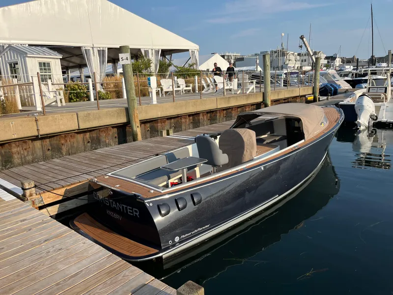 Slide: The Image of 2022 AdmiralsTender C28 boat docked at a marina, featuring sleek design and modern amenities. - 1