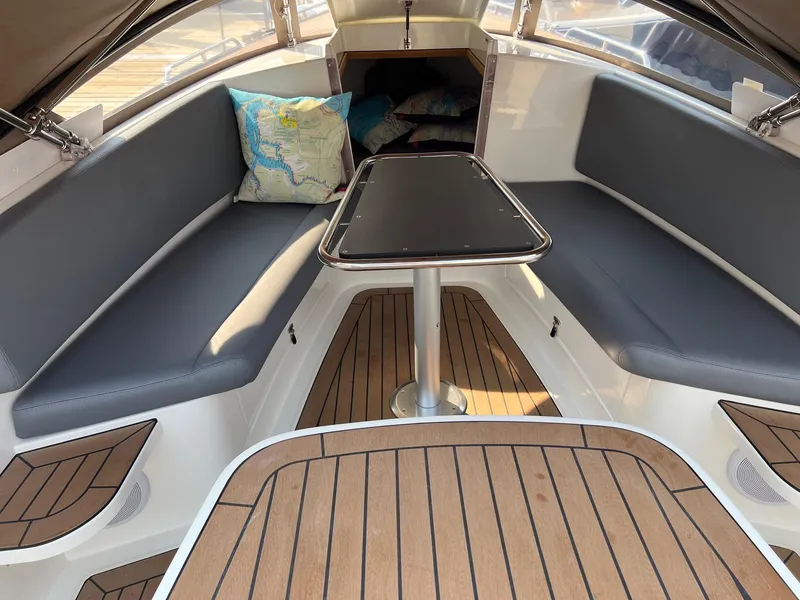 Slide: The Image of 2022 AdmiralsTender C28 boat interior with cushioned seating and wooden flooring. - 11