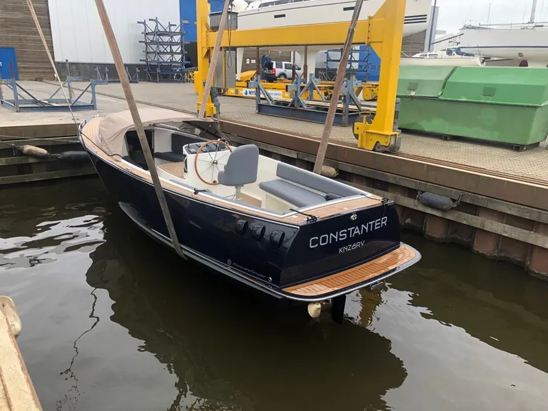 Slide: The Image of 2022 AdmiralsTender C28 boat docked, featuring sleek design and modern amenities. - 9