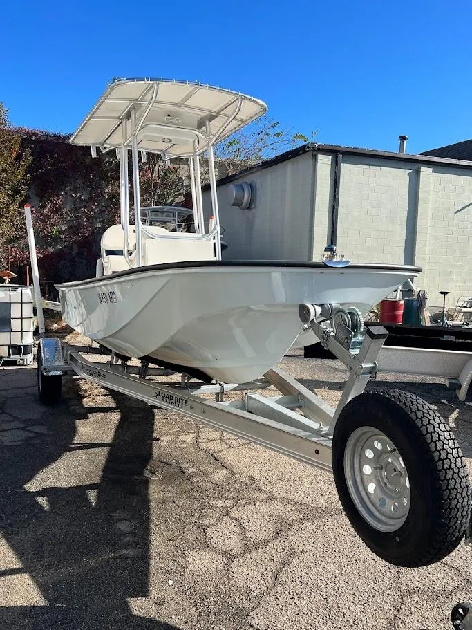Slide: The Image of 2022 Boston Whaler 17 Montauk boat on trailer, parked outdoors. - 2