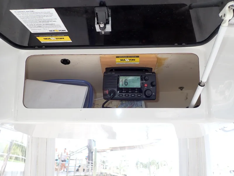 Slide: The Image of 2016 Tidewater 230 CC Adventure boat radio compartment with equipment. - 13