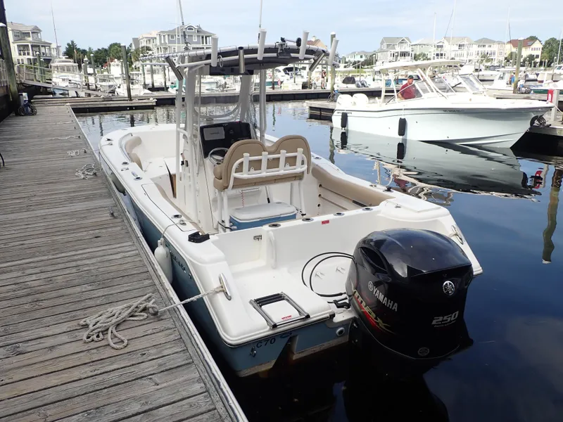 Slide: The Image of 2016 Tidewater 230 CC Adventure boat docked in marina with Yamaha 250 engine. - 2