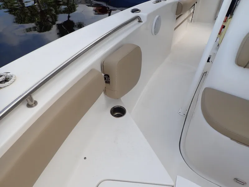 Slide: The Image of 2016 Tidewater 230 CC Adventure boat interior with beige seating and stainless steel rail. - 21