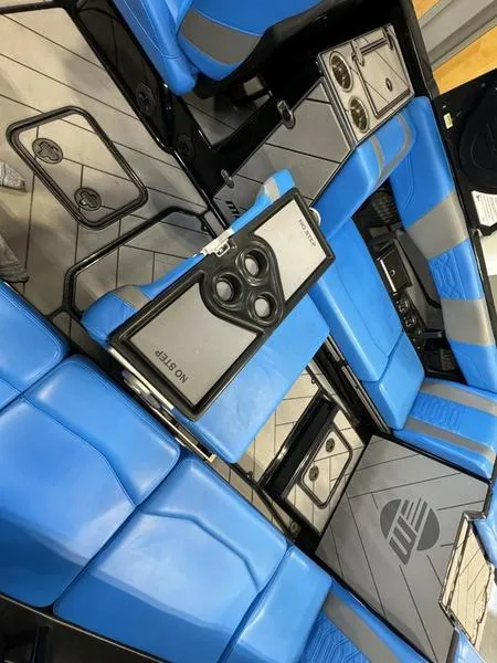 Slide: The Image of 2022 Malibu 25 LSV interior with blue seating and modern design. - 18