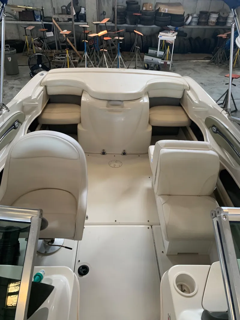 Slide: The Image of 2004 Sea Ray 200 Sport boat interior with white seating in a garage setting. - 11