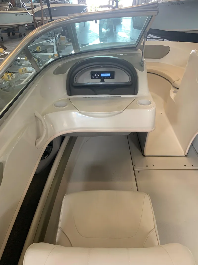 Slide: The Image of 2004 Sea Ray 200 Sport boat interior with dashboard and seating. - 15