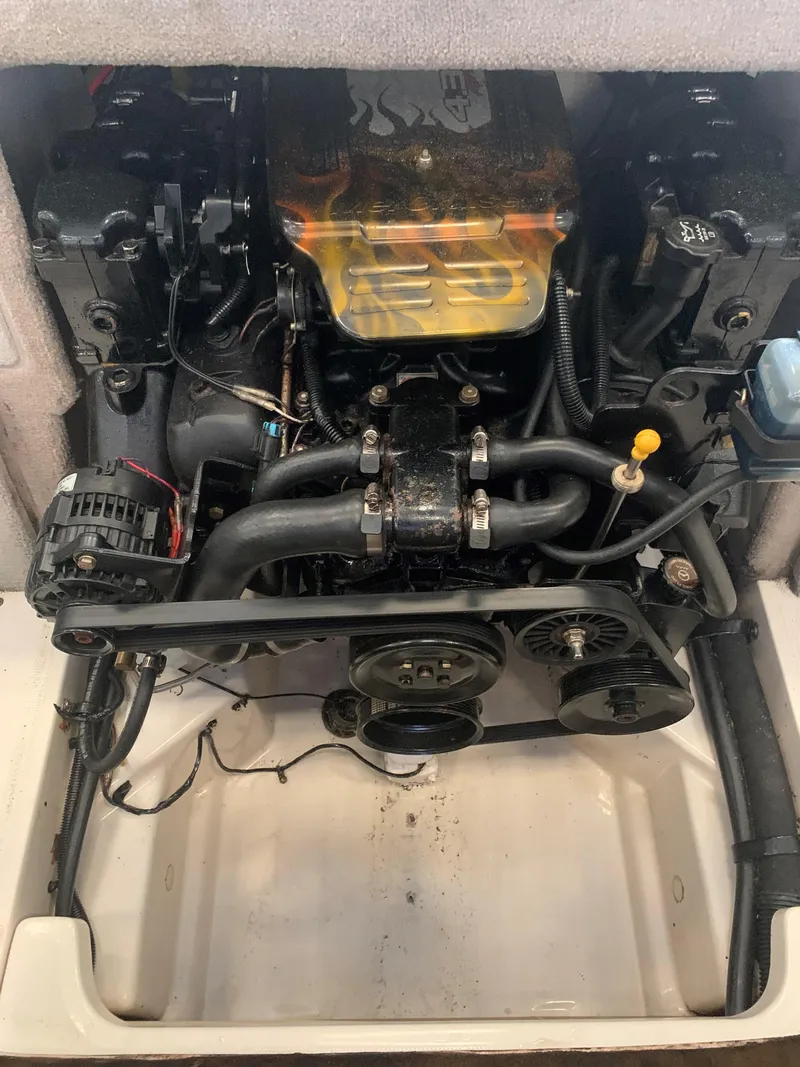 Slide: The Image of 2004 Sea Ray 200 Sport engine compartment with visible components and wiring. - 16