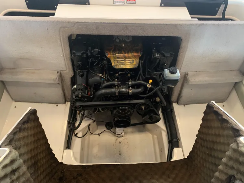 Slide: The Image of Engine compartment of a 2004 Sea Ray 200 Sport boat, showcasing mechanical components. - 17