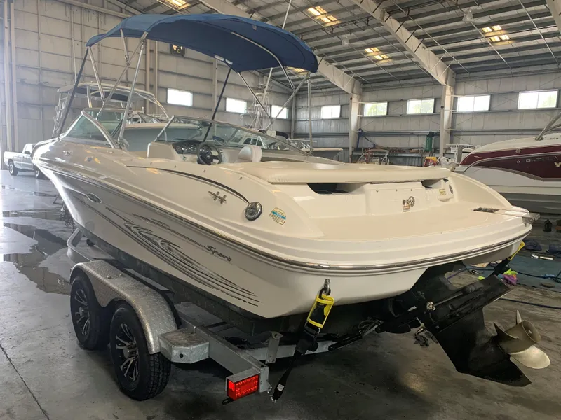 Slide: The Image of 2004 Sea Ray 200 Sport boat on trailer in indoor storage facility. - 2