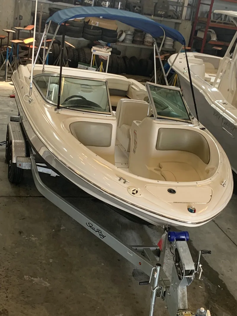 Slide: The Image of 2004 Sea Ray 200 Sport boat with blue canopy on trailer in garage. - 5