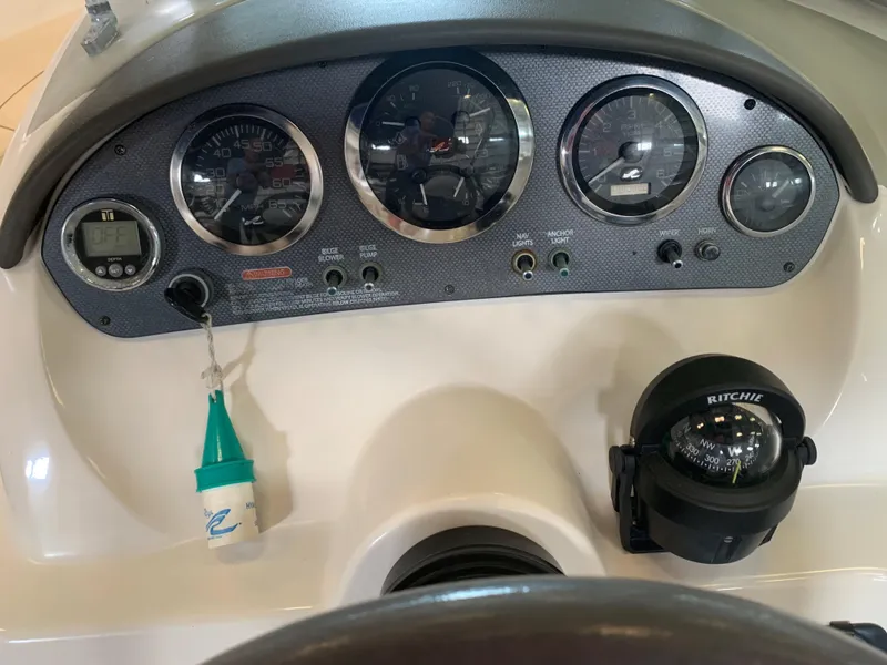 Slide: The Image of Dashboard of a 2004 Sea Ray 200 Sport boat with gauges and compass. - 8