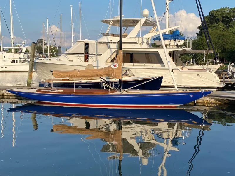 Slide: The Image of 2023 C.W. Hood 32 Daysailer docked at marina, reflecting on calm water. - 2