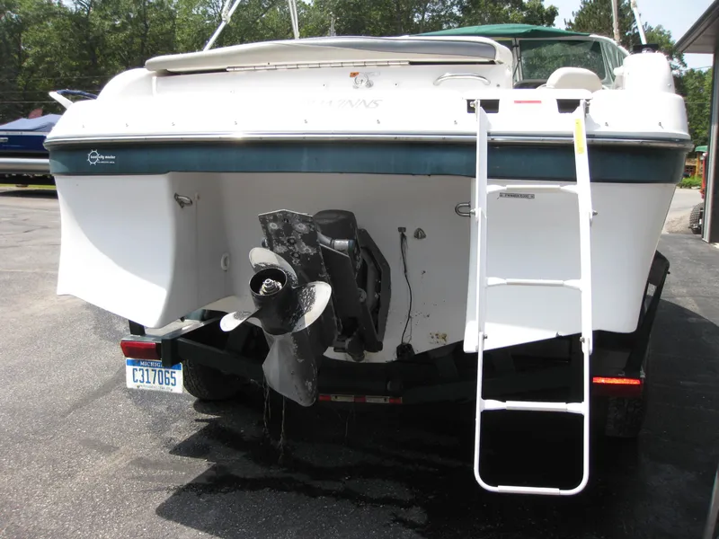 Slide: The Image of 2000 Four Winns 235 Sundowner I/O boat rear view with ladder and propeller. - 20