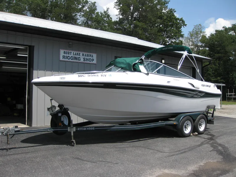 Slide: The Image of 2000 Four Winns 235 Sundowner I/O boat on trailer outside rigging shop. - 21