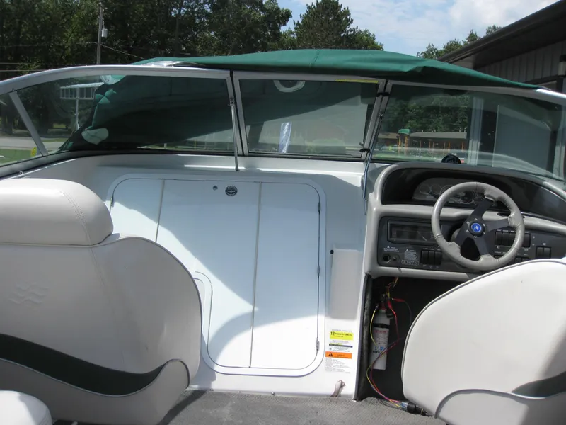 Slide: The Image of Interior view of 2000 Four Winns 235 Sundowner I/O boat cockpit. - 4