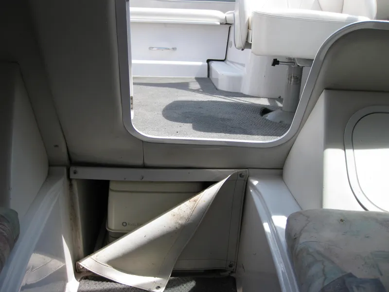 Slide: The Image of Interior view of 2000 Four Winns 235 Sundowner I/O boat, showing seating and storage area. - 6