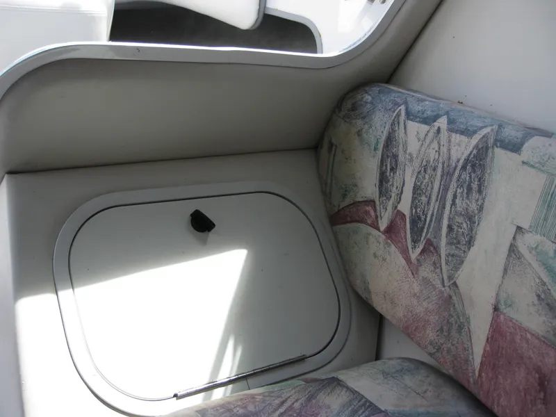 Slide: The Image of Interior of 2000 Four Winns 235 Sundowner I/O with patterned seating and storage compartment. - 8
