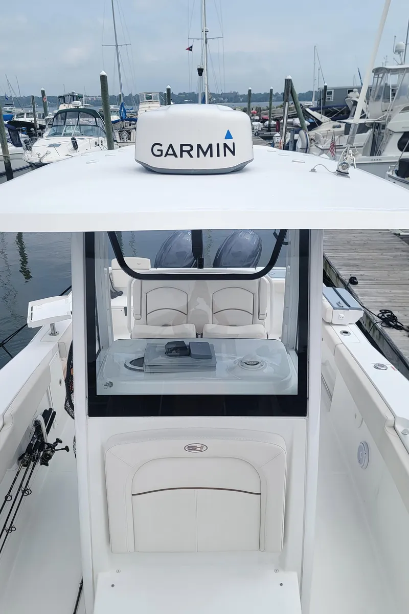 Slide: The Image of 2020 Sea Hunt Gamefish 27 boat with Garmin equipment, docked at a marina. - 15