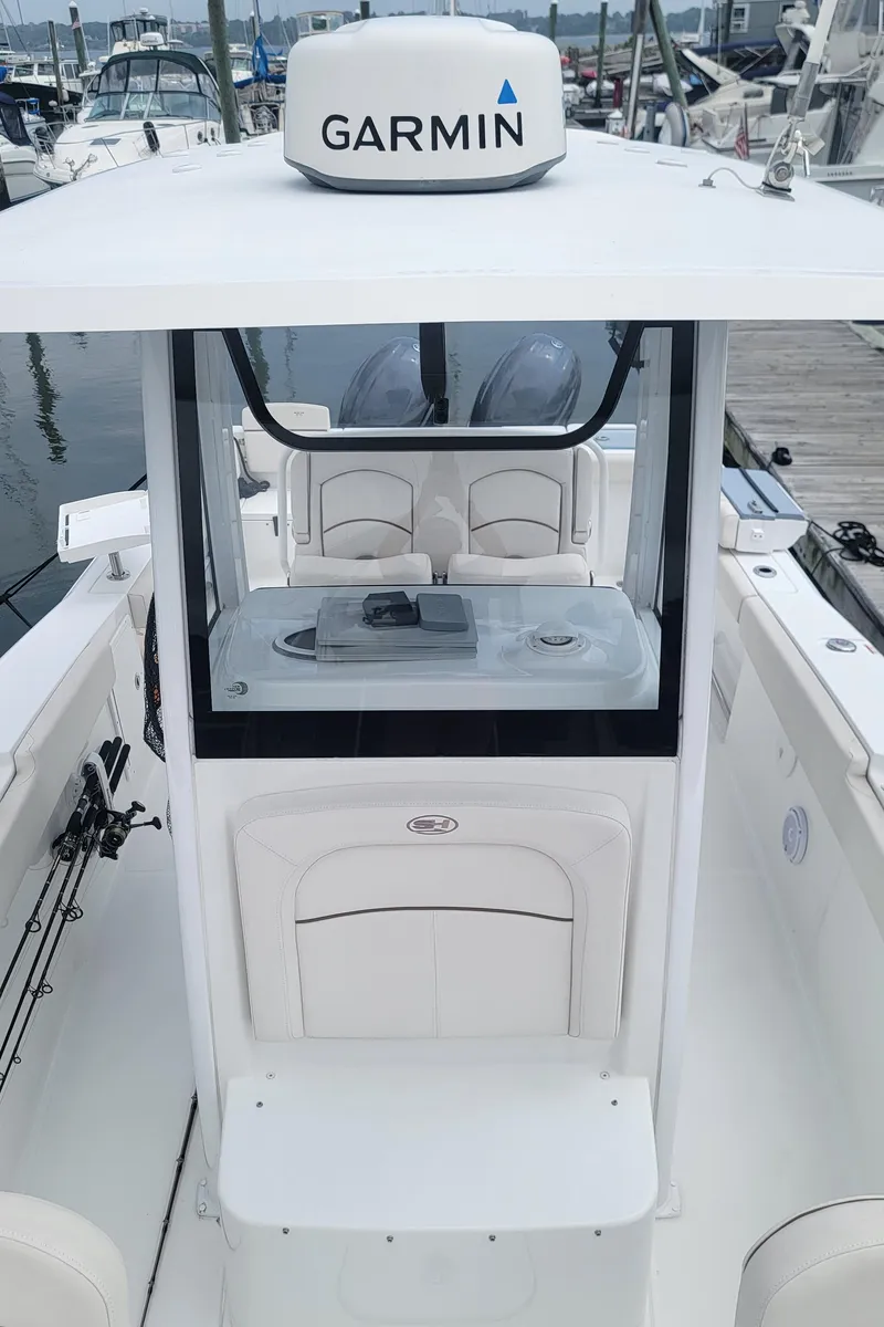 Slide: The Image of 2020 Sea Hunt Gamefish 27 with Garmin equipment, docked at a marina. - 18