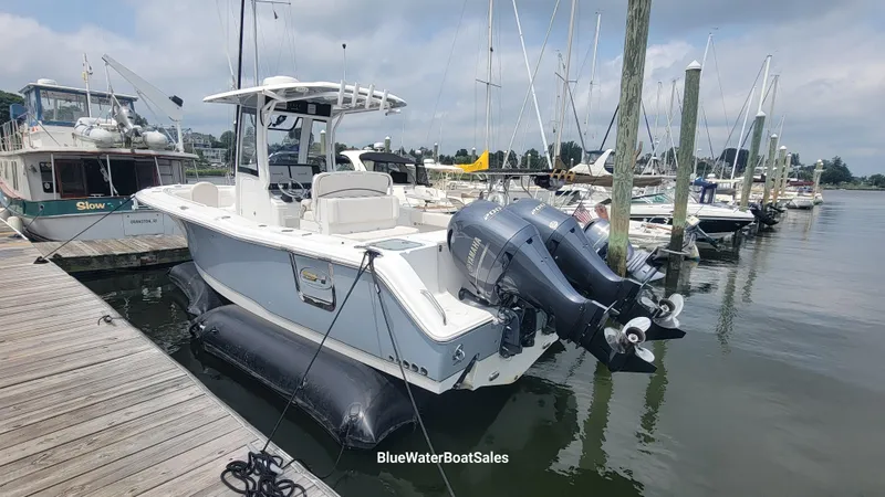 Slide: The Image of 2020 Sea Hunt Gamefish 27 boat docked with twin engines, featuring forward seating. - 2