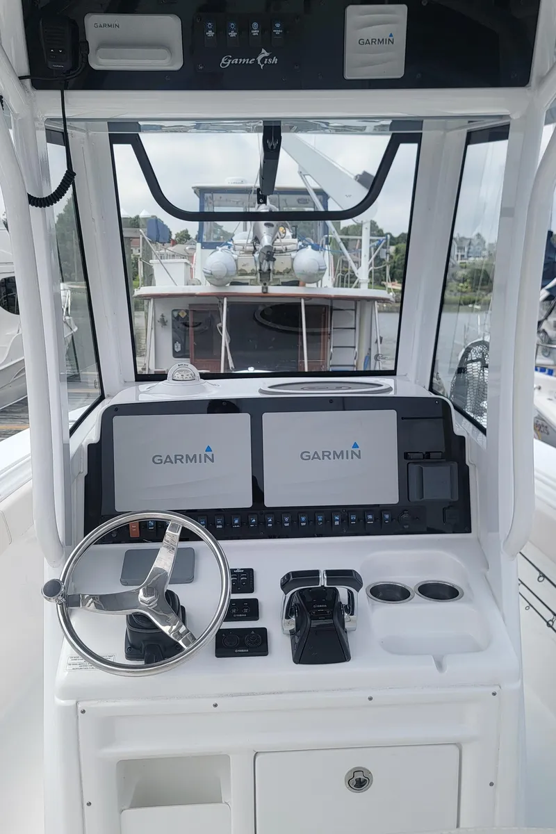 Slide: The Image of 2020 Sea Hunt Gamefish 27 helm with Garmin navigation displays and steering wheel. - 7