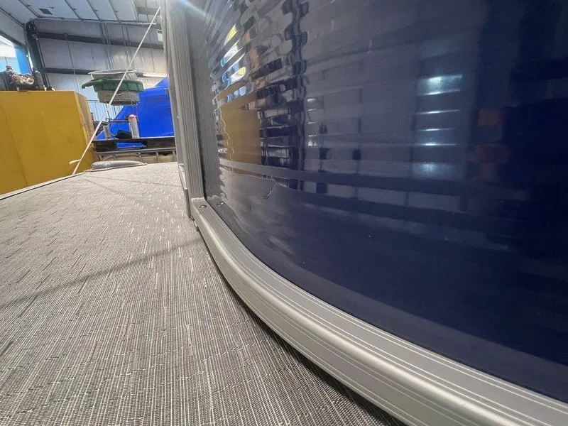 Slide: The Image of 2023 Bennington 22 SSR pontoon boat in a warehouse setting. - 19