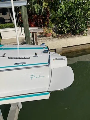 Slide: The Image of Cherubini 20 VS 2013 boat docked near lush greenery and water. - 13